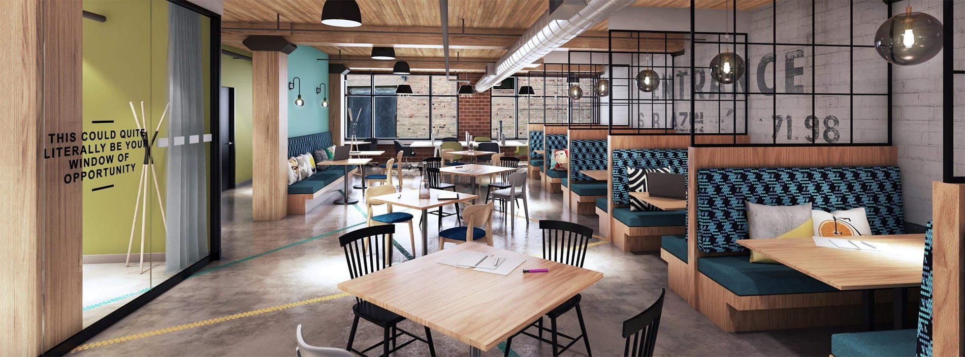 A creative coworking space with booth seating, high tables, and industrial exposed brick